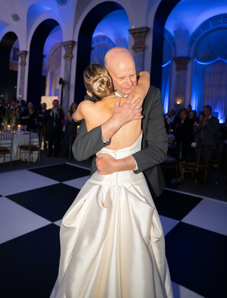 Bride sharing a hug with her father for the father daughter dance