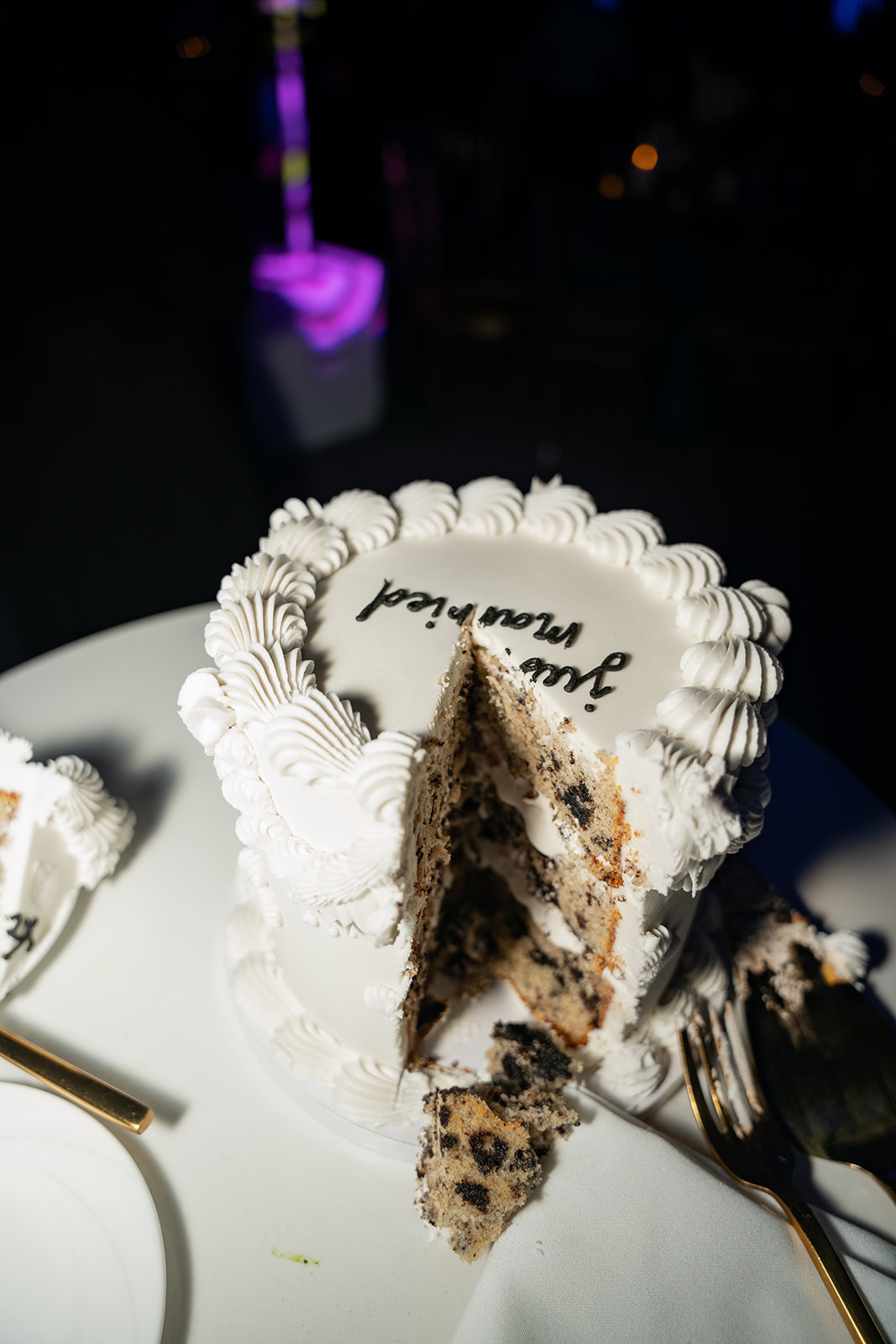 Sliced wedding cake shot in editorial flash style