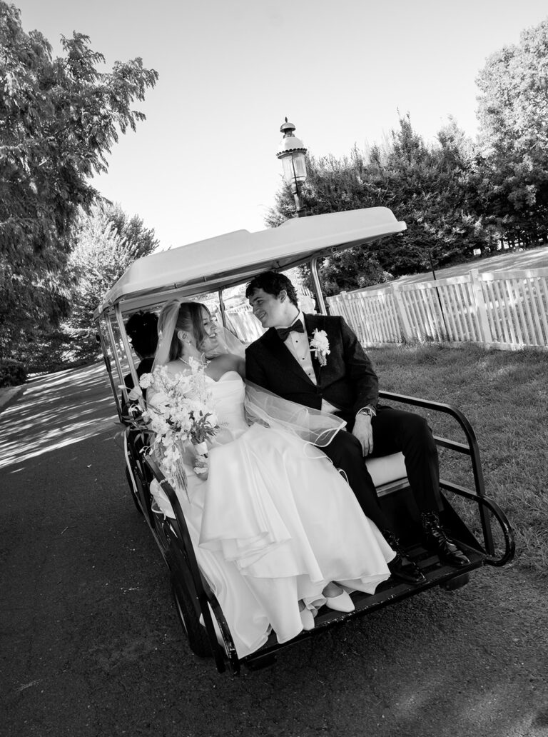 Wedding day couple share an intimate moment in a golf cart at Celebrate at Snug Harbor in Staten Island, New York.