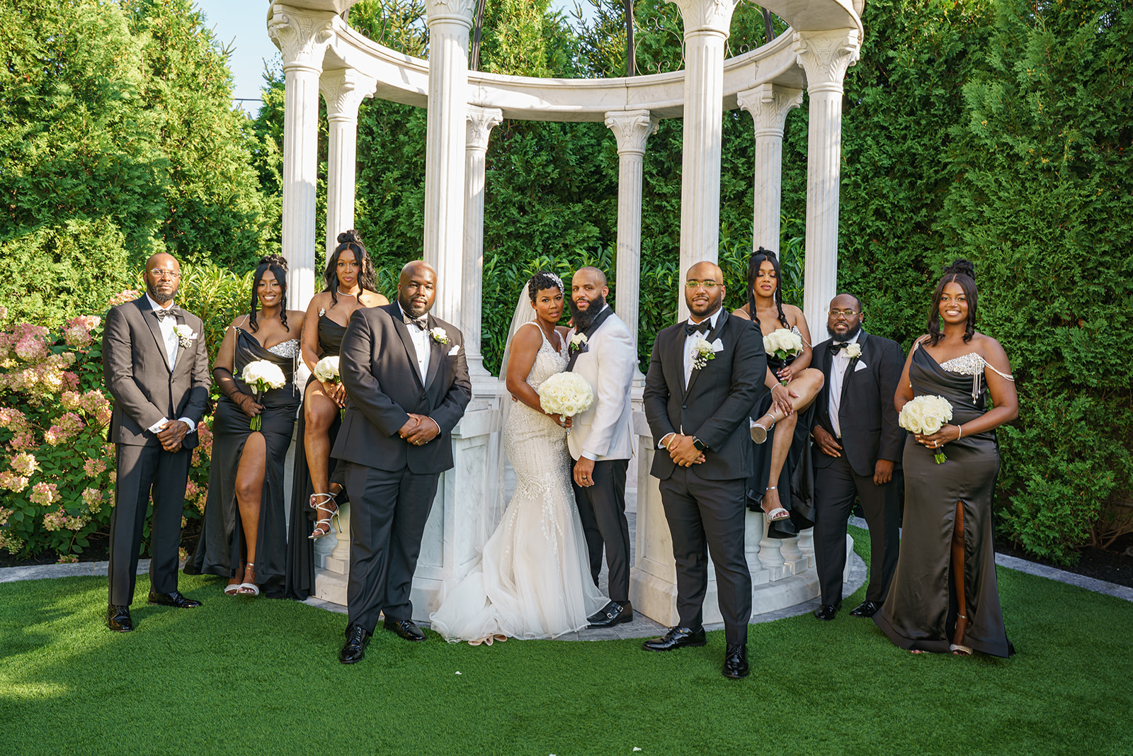 Black bridal party posing in all black